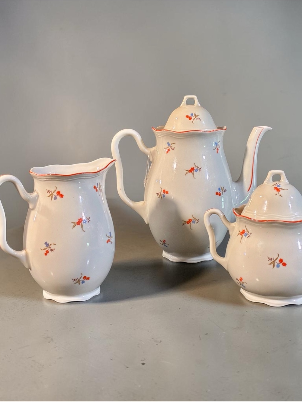 German Egerland porcelain tea set with floral pattern and red trim, MMC P mark.